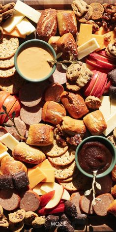 an assortment of cheeses, crackers and other snacks