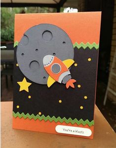 an orange and black card with a rocket ship on it's side that says you're a blast