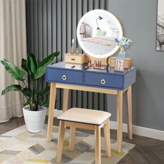 a blue vanity table with a mirror and stool in front of it on top of a rug