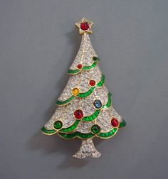 Handmade brooch This is a gorgeous silver Christmas tree shaped brooch. Metal- Sterling silver Diamond Wt - 2.99Ct Diamond Color - White Diamonds- American Diamonds Diamonds shape- Round Gemstone- Emerald,Ruby, Blue sapphire, Yellow topaz(Lab created) Dimension-- 3.5 inch Silver Wt - 14.25gm Silver Finish - White/Gold Plated Finished Silver Purity - 925 Sterling Silver Brooch Would you like to give a nice pin gift to your loved ones on New Year's Eve? With this Christmas Tree Brooch, you can giv Nordstrom Christmas, Brooch Christmas Tree, Swarovski Christmas Tree, Swarovski Christmas, Christmas Bling, Christmas Brooch, Silver Christmas Tree, Beautiful Christmas Trees, Antique Brooches