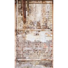 an old brick wall with peeling paint and rusted metal bars hanging from it's sides