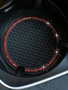 a close up of a car's center console with red and silver sparkles