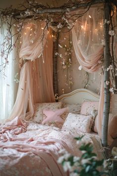 a bed with pink sheets and pillows in a room decorated with branches, flowers and lights