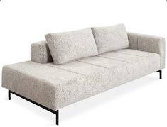 a gray couch sitting on top of a white floor next to a black metal frame