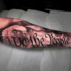 an eagle with the words we are people on it's arm, and its head in