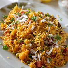 a white plate topped with rice and veggies