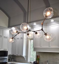 a chandelier hanging from the ceiling in a kitchen