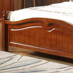 a bed with wooden headboard and foot board