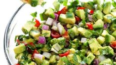 a glass bowl filled with chopped up vegetables