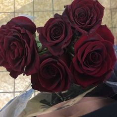 a bunch of red roses sitting in a vase