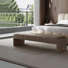 a bedroom with a large bed and a bench on the floor in front of it