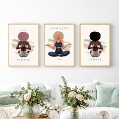 three posters with woman doing yoga on the wall above a couch and coffee table in front of them