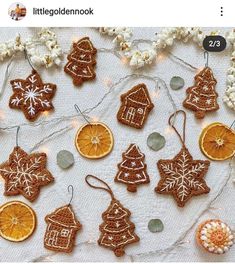 some orange slices and cookies are on a table with christmas decorations hanging from it's sides