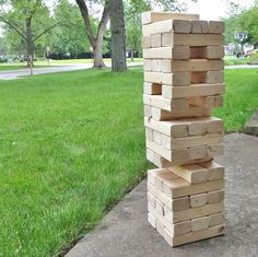 a stack of wooden blocks sitting in the grass