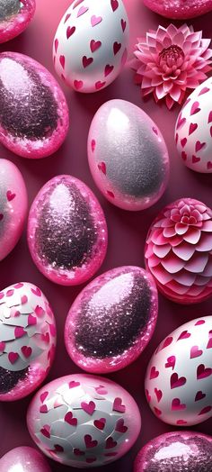 pink and white eggs with hearts on them are arranged in a pattern that looks like flowers