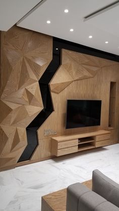 a modern living room with wood paneling on the wall and tv in the center