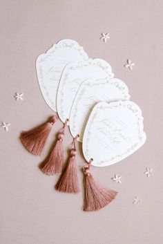 four cards with tassels on top of them