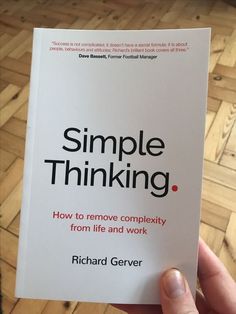 a person holding up a book with the title'simple thinking how to remove complexity from life and work '