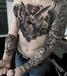 a man with lots of tattoos on his chest and arm is posing for the camera