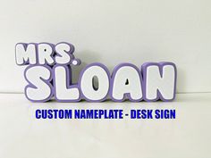 the word mrs sloan is made up of purple letters and blue lettering that read, custom nameplate - desk sign