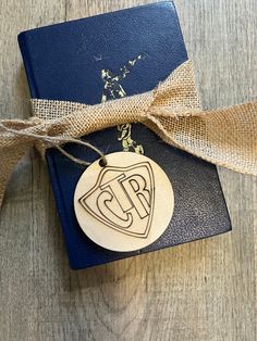 a wooden ornament on top of a book tied to a burlock