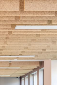 an empty room with wooden planks on the ceiling