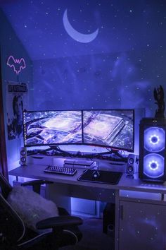 two computer monitors sitting on top of a desk in front of a moon and stars wallpaper