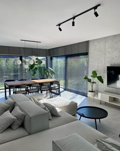 a living room filled with furniture and a flat screen tv on top of a wooden table