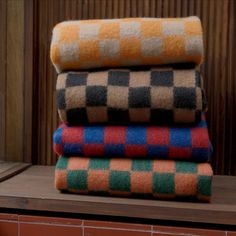 four different colored towels stacked on top of each other