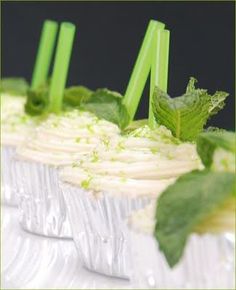 cupcakes decorated with green leaves and frosting