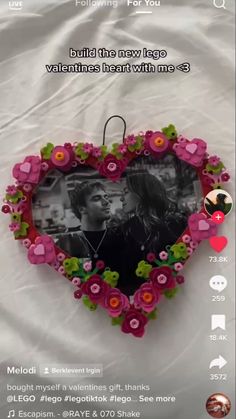 a heart shaped frame with flowers on it