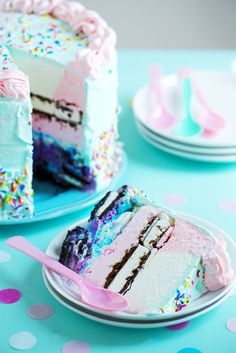 a slice of cake with sprinkles on it and a pink spoon in the foreground