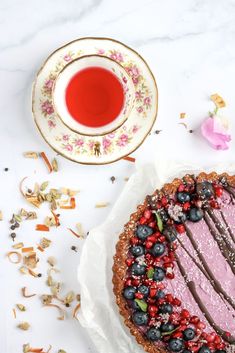 a piece of cake on a plate next to a cup and saucer with flowers