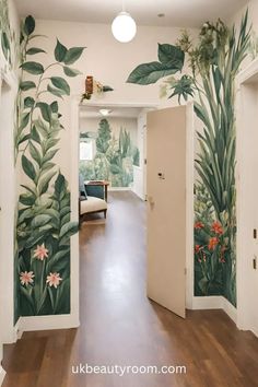 an open door leading to a hallway with plants painted on the walls and wooden floors