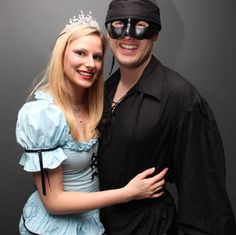 a man and woman dressed up in costumes posing for a photo with a mask on