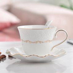 a coffee cup and saucer sitting on a table