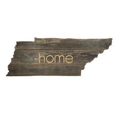 a wooden state shaped sign with the word home written in gold on it's side