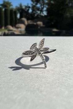 "A timeless and classic design, symbolizing strength and everlasting love. Perfect for everyday wear or dressed up for special occasions. Make a bold statement in our Genuine Diamond Dragonfly Ring, handcrafted in 14k white gold.  Item Specifications: Materials: 14k White Gold  Gemstone: Natural Diamond Dragonfly Diameter: 11.6mm x 11.6mm Total Gold Weight: 1.69 ct. Total Diamond Carat Weight: 0.10 ct. Diamond Clarity: SI 1-2 Diamond Color: G-H color ★  Each order will be beautifully packaged in a jewelry box and comes with a drawstring pouch that's perfect for travel. LiebeJewelry's products are handcrafted and all materials are genuine and ethically sourced. If you have any additional questions about this ring, just hit the \"Ask a Question\" button (just to the right of the price) and w Elegant Sterling Silver Diamond White Butterfly Ring, Elegant Sterling Silver Butterfly Ring In Diamond White, Elegant Diamond White Sterling Silver Butterfly Ring, Elegant Silver Butterfly Ring With Vvs Clarity, Luxury Sterling Silver Butterfly Ring For Anniversary, Elegant Sterling Silver Butterfly Ring For Anniversary, Fine Jewelry White Gold Butterfly Ring As Gift, Fine Jewelry White Gold Butterfly Ring For Gift, Formal Silver Butterfly Ring With Brilliant Cut