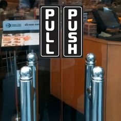 two signs that say push in front of a counter