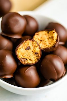 a bowl filled with chocolate covered candies on top of a table