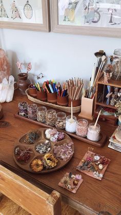 a wooden table topped with lots of crafting supplies on top of it's sides