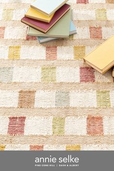 a pile of books sitting on top of a rug