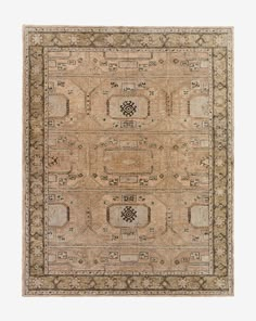 an antique rug with many different patterns and colors on the carpet, including beiges and browns