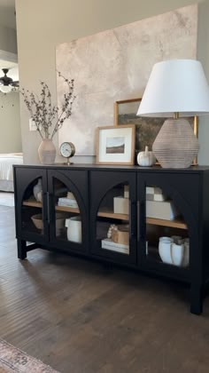 a living room with a large black entertainment center