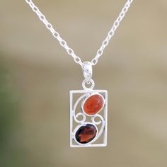 Two fiery gemstones--glossy orange carnelian and deep crimson garnet--make excellent bedfellows on Neeru Goel's pendant necklace. Indian artisans use sterling silver to hand craft the necklace, accenting the openwork pendant with smooth carnelian and faceted garnet. Carnelian Gemstone Pendant Jewelry, Silver Carnelian Bohemian Necklace, Bohemian Carnelian Pendant Jewelry, Silver Carnelian Pendant Necklace, Red Garnet Pendant Necklace, Silver Smithing, Orange Carnelian, Carnelian Pendant, Necklace Indian