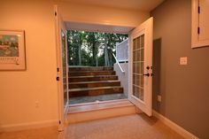 an empty room with stairs leading up to the second floor