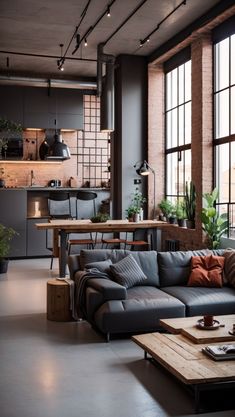 a living room filled with lots of furniture and large windows next to a kitchen area