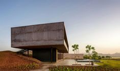 a concrete structure sitting on top of a lush green field