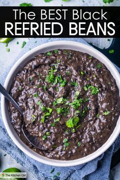 A bowl of black refried beans garnished with chopped cilantro. A spoon is placed in the bowl. The text The BEST Black Refried Beans is at the top of the image. Refries Black Beans Recipe, Black Bean Refried Beans, Omnivore Recipes, Refried Black Beans, Honduran Recipes, Mexican Favorites, Mexican Black Beans, Refried Beans Recipe, Black Bean Recipes