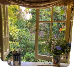 an open window overlooking a lush green forest